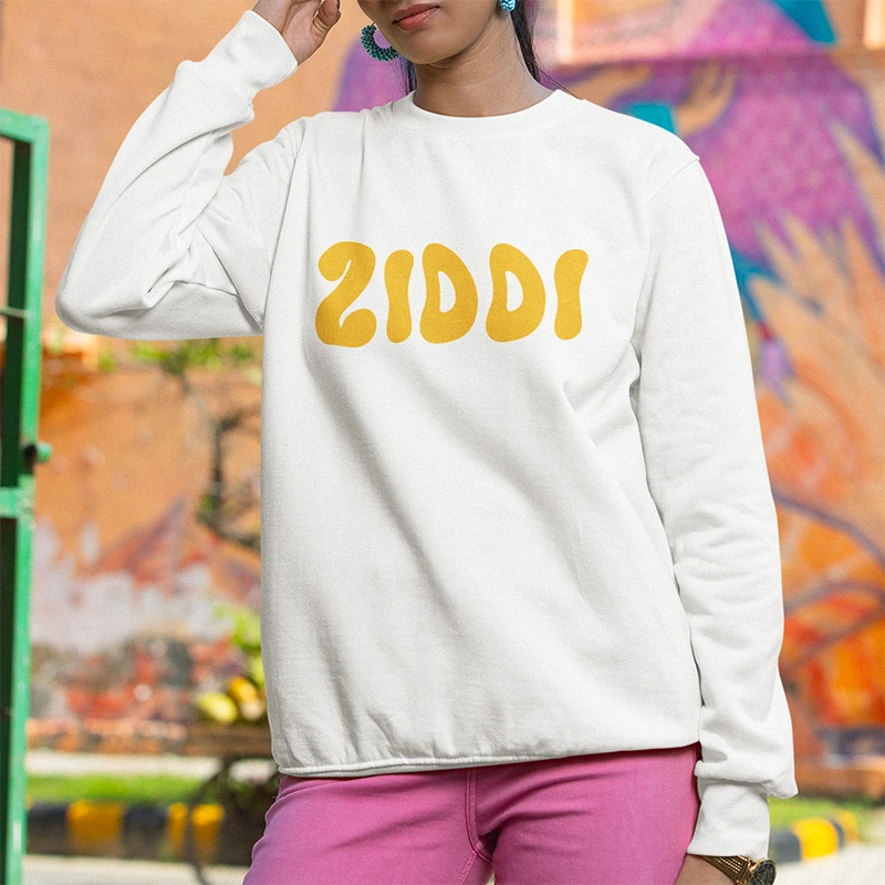 A woman wearing a white Ziddi branded sweatshirt