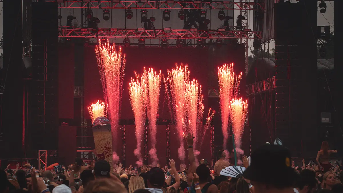 Photo of a music festival with fireworks infront of the main stage.