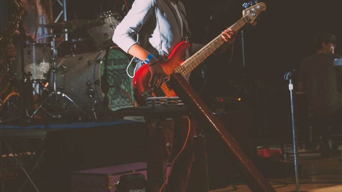 A man playing guitar live.