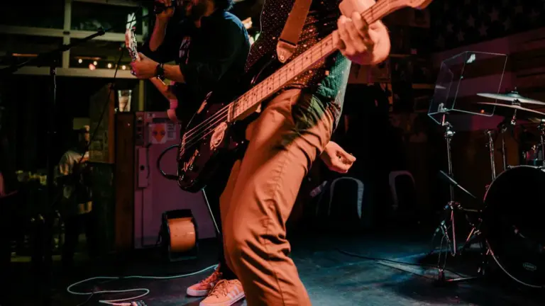 A band playin music live and a man holding a guitar.